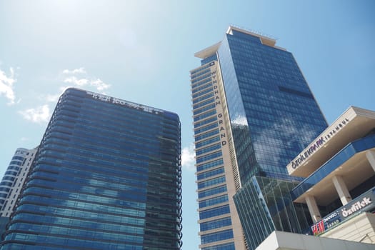 Two impressive skyscrapers stand tall against a clear blue sky.