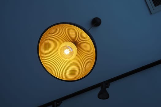 A chic pendant light hangs from the ceiling, casting warm illumination.