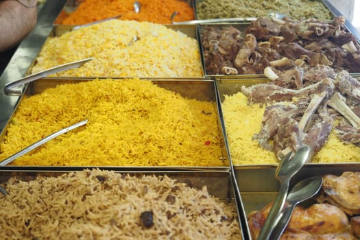 Vibrant varieties of rice available for purchase in a local market.
