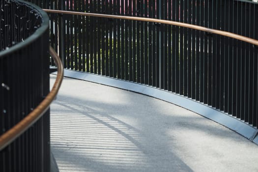 Smooth walkway with railing fosters tranquility in urban spaces.