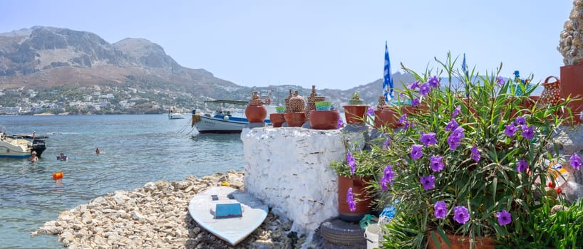 Telendos Greece - August 29 2024; Waterfront scene on Telendos Island with quaint traditional fishing boats and fishermen.