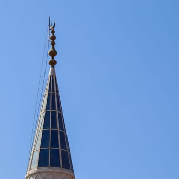 Mosque Minaret on a background of blue sky in Bitez, Bodrum, Turkiye