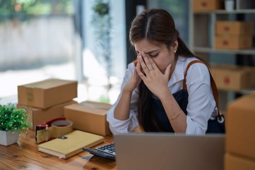 Young woman engaged in online business with stress thoughtful within data products Sales did not meet target Selling products of This month.
