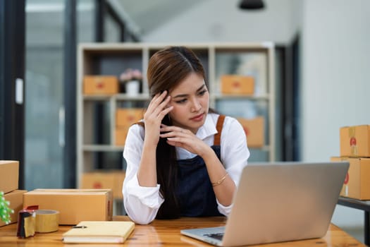 Young woman engaged in online business with stress thoughtful within data products Sales did not meet target Selling products of This month.