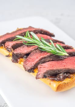 Crispy ciabatta filled with melted cheese, tender steak, sweet onions, and fresh rosemary