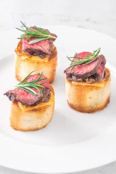 Crispy baguette filled with melted cheese, tender steak, sweet onions, and fresh rosemary