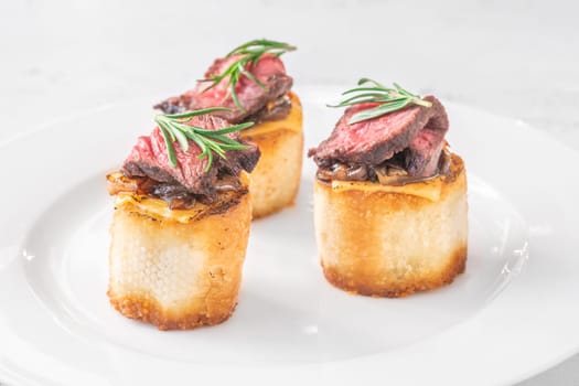 Crispy baguette filled with melted cheese, tender steak, sweet onions, and fresh rosemary