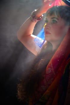 A middle-aged woman showcases her beauty in a vibrant sari, embodying Indian culture during a creative blogging session.