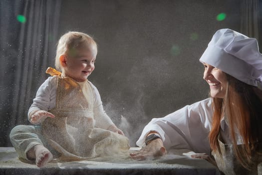 A mother and daughter joyfully engage in a flour-filled moment, creating memories in a cozy kitchen setting.