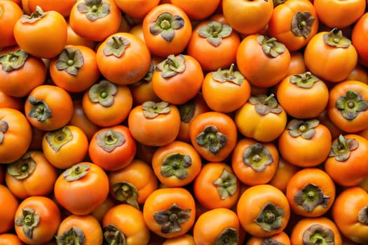 A close-up view of fresh persimmons, showcasing their vibrant orange color and unique textures, perfect for seasonal fruit themes, healthy food, and nature-inspired visuals.