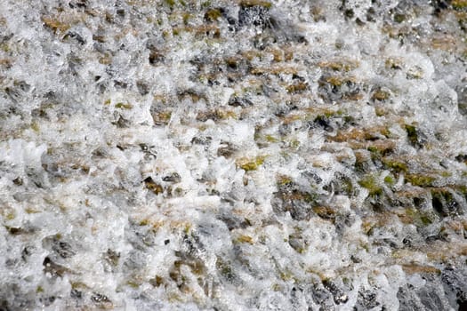 water foaming and running down the mountain close up , summer