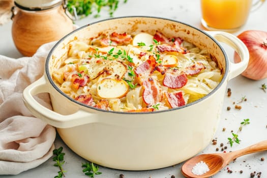 A hearty baked cabbage casserole featuring layers of tender cabbage, crispy bacon, and creamy sauce sits on a kitchen table, accompanied by herbs and onions.