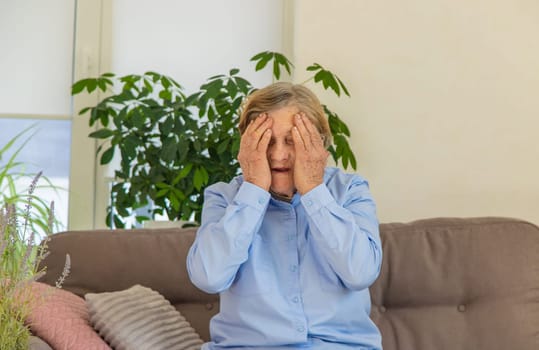 Old woman headache. Selective focus people
