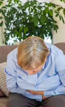 Old woman has stomach ache. Selective focus. people,