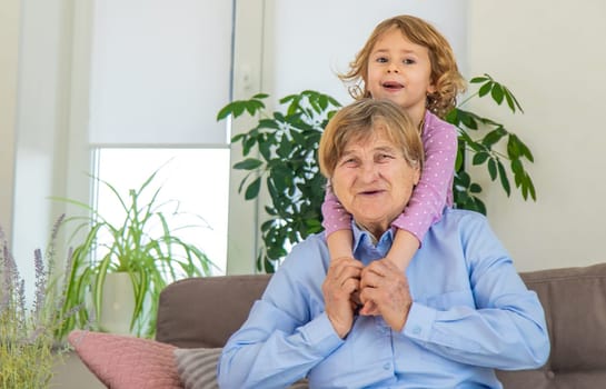 Old woman with her granddaughter. Selective focus. People,