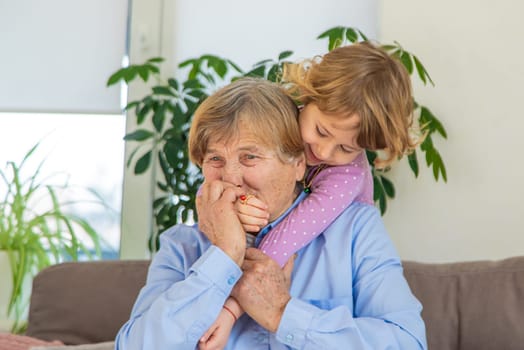 Old woman with her granddaughter. Selective focus. People,