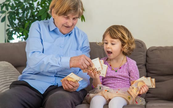 Old woman with her granddaughter. Selective focus. People,