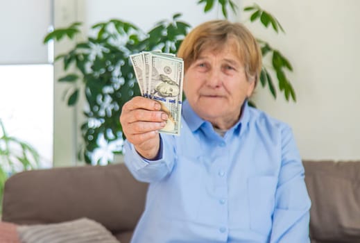 Old woman with money. Selective focus. People,