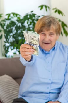 Old woman with money. Selective focus. People,