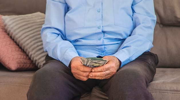 Old woman with money. Selective focus. People,