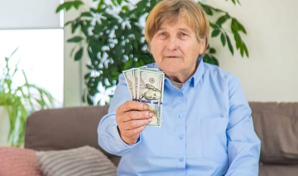 Old woman with money. Selective focus. People,