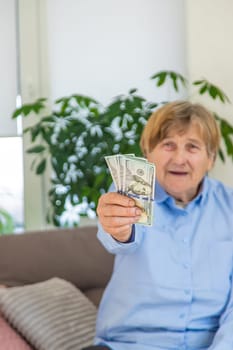 Old woman with money. Selective focus. People,