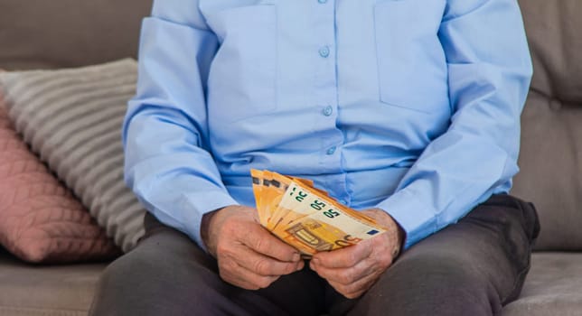 Old woman with money. Selective focus. People,