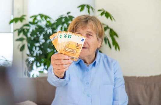 Old woman with money. Selective focus. People,