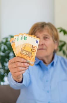 Old woman with money. Selective focus. People,