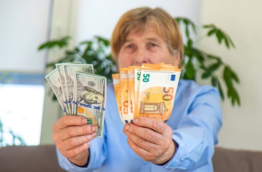 Old woman with money. Selective focus. People,