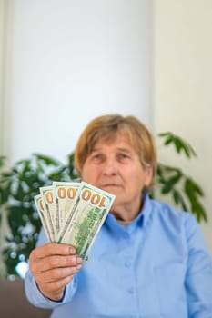 Old woman with money. Selective focus. People,