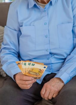 Old woman with money. Selective focus. People,