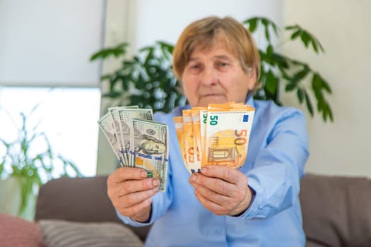 Old woman with money. Selective focus. People,