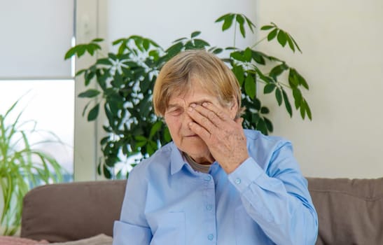 old woman eyes hurt. Selective focus. people.