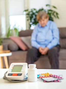 An old woman measures her blood pressure. Selective focus. people,
