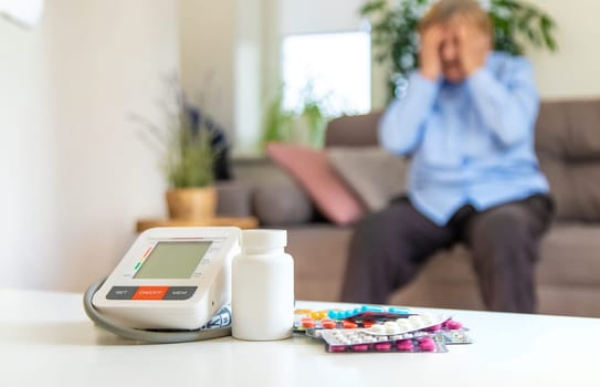 An old woman measures her blood pressure. Selective focus. people,