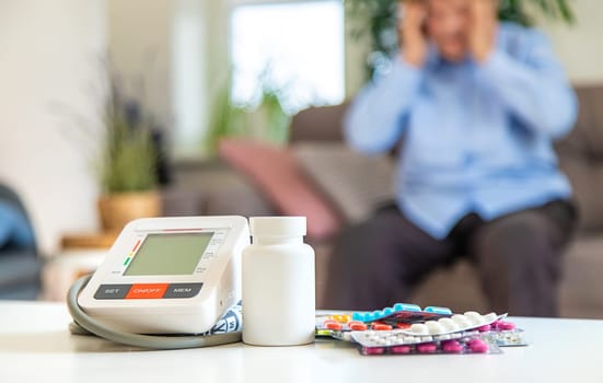 An old woman measures her blood pressure. Selective focus. people,