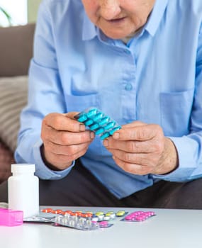 Old woman with medicine. Selective focus. people,