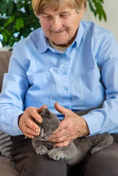 Old woman with a cat. Selective focus. People,