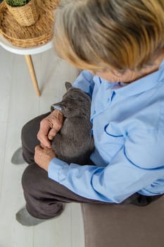 Old woman with a cat. Selective focus. People,