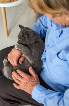 Old woman with a cat. Selective focus. People,