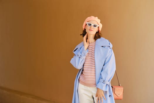 Cheerful positive woman in stylish colorful outfit posing outdoor