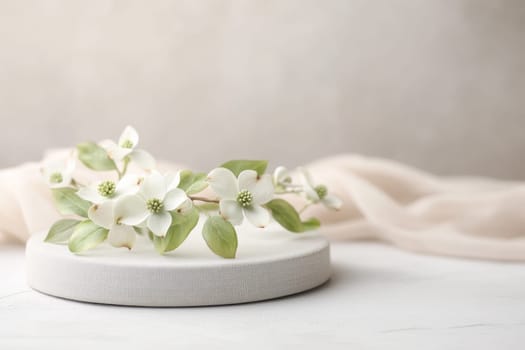 A lovely arrangement of white flowers with green leaves sits on a soft, neutral podium that highlights the essence of spring.