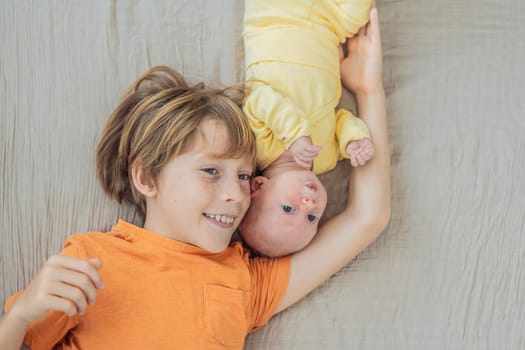 A young boy and his newborn brother lie together on a soft muslin blanket, sharing a tender sibling moment. A heartwarming scene of brotherly love, bonding, and the beginning of a lifelong connection.