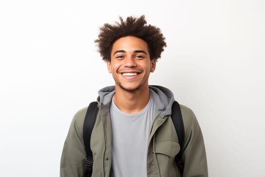 Portrait of happy modern young black American man smiling on white background, African male student with backpack looking at camera, studio shot