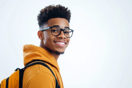 Portrait of happy modern young black American man with glasses smiles on white background, African male student with backpack looking at camera, studio shot