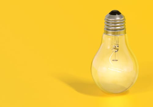 Light bulb on yellow background, creative ideas concept