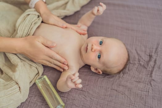 A mother gently massages her 1-month-old baby with baby oil after a bath. This tender moment highlights the bond between parent and child, promoting relaxation, baby care, and the importance of skin-to-skin contact.