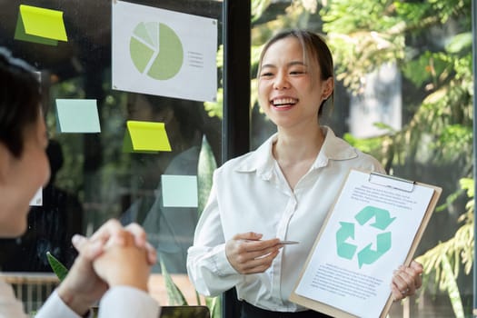 An enthusiastic presenter shares her ideas on recycling and sustainability strategies while fostering a collaborative mindset among colleagues.