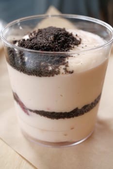 Creamy dessert features layers of chocolate and fruit flavors in a cup.